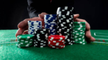 Businessman hands pushing gambling chips.