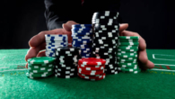 Businessman hands pushing gambling chips.
