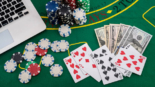 poker chips with banknotes placed on a laptop keyboard. Poker concept